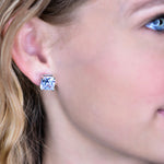10 mm square cut cubic zirconia imbedded in gold frame earrings in ear.