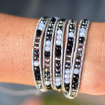 Black and Gray Beads on Gray Leather Wrap Bracelet on wrist.