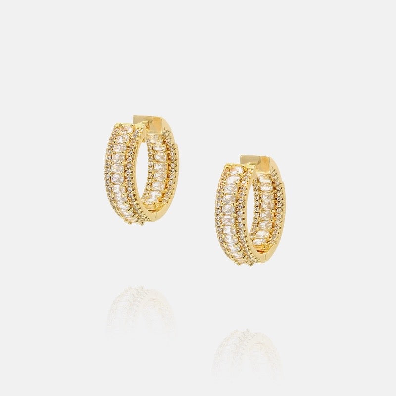 18K gold plated hoop earrings decorated with cubic zirconia on outside and inside of the hoop.