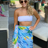 Blue sarong with yellow, green, and pink floral design.