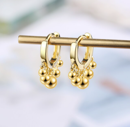 Small gold hoop with tasseled gold beads.