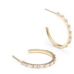 Small gold hoop earrings with clear baguette CZ stones lining the hoop