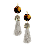 Earrings with large gray tassel adorned with mint beads connected to celluloid tortoise discs.